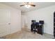 This functional bedroom has carpet, a ceiling fan, neutral walls, and a workspace with two monitors at 5396 Pennington Ct, South Fulton, GA 30349
