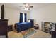 Bright bedroom featuring a ceiling fan, plush carpet, bed, and a colorful play area with a toy kitchen at 5396 Pennington Ct, South Fulton, GA 30349