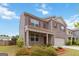 Beautifully landscaped yard of a brick two-story home featuring a covered porch at 5396 Pennington Ct, South Fulton, GA 30349