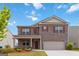 Charming brick two-story home featuring a covered porch and a two-car garage at 5396 Pennington Ct, South Fulton, GA 30349