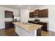 Spacious kitchen with stainless steel appliances, a large island, and dark wood cabinets at 5396 Pennington Ct, South Fulton, GA 30349