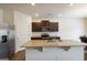 Modern kitchen featuring stainless steel appliances, a large island, and dark wood cabinets at 5396 Pennington Ct, South Fulton, GA 30349