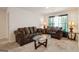 Cozy living room with comfortable sofas, glass coffee table, and bright windows at 5396 Pennington Ct, South Fulton, GA 30349