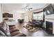 Spacious living room featuring a fireplace, leather couches, and wood flooring at 5396 Pennington Ct, South Fulton, GA 30349