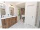 Stylish bathroom featuring a double vanity, decorative tile floors, and a luxurious glass enclosed shower at 185 Chimney Springs, Tyrone, GA 30290