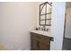 Charming powder room with modern vanity, unique mirror and fixtures at 185 Chimney Springs, Tyrone, GA 30290