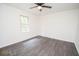 A well-lit bedroom boasts sleek wood-look floors and a large window with a view of the trees at 185 Chimney Springs, Tyrone, GA 30290