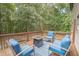Relaxing outdoor deck featuring comfortable seating and serene view of the surrounding woods at 185 Chimney Springs, Tyrone, GA 30290