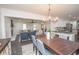Open-concept dining area connecting to a living room and kitchen with modern finishes at 185 Chimney Springs, Tyrone, GA 30290