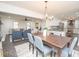Dining area with a modern chandelier that opens to a kitchen and living space at 185 Chimney Springs, Tyrone, GA 30290