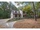 Two-story home with a brick facade, wood shutters, and mature trees at 185 Chimney Springs, Tyrone, GA 30290