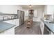 Modern kitchen features white cabinets, stainless steel appliances, and an island with wood accents at 185 Chimney Springs, Tyrone, GA 30290