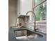 Close up on kitchen sink with modern faucet, granite countertop, and window view to the outdoors at 185 Chimney Springs, Tyrone, GA 30290