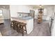 A kitchen with white cabinets, gray countertops, stainless steel appliances, and a wood island at 185 Chimney Springs, Tyrone, GA 30290