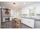 Bright kitchen with stainless steel appliances, a kitchen island, white cabinets, and stylish backsplash at 185 Chimney Springs, Tyrone, GA 30290
