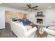 Open-concept living room featuring a brick fireplace, modern ceiling fan, and hardwood flooring at 185 Chimney Springs, Tyrone, GA 30290