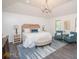 Spacious main bedroom features a statement chandelier, stylish decor, and lots of natural light at 185 Chimney Springs, Tyrone, GA 30290