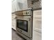 Close-up of stainless steel oven and white cabinets, showcasing modern kitchen design at 185 Chimney Springs, Tyrone, GA 30290