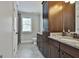 Well-lit bathroom with dual vanities, granite countertops, and a separate shower for convenience at 210 Short Rd, Sharpsburg, GA 30277