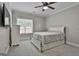 Well-lit bedroom features a ceiling fan, a window, and a white sleigh bed with storage drawers at 210 Short Rd, Sharpsburg, GA 30277
