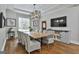 Dining room with large wood table, modern chandelier, and natural light at 210 Short Rd, Sharpsburg, GA 30277