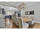 Dining room with a modern chandelier, large table, and view into the kitchen at 210 Short Rd, Sharpsburg, GA 30277