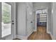 Hallway with beautiful hardwood flooring, leading to a kitchen with custom cabinetry and appliances at 210 Short Rd, Sharpsburg, GA 30277