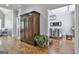 Hallway featuring hardwood floors and an antique armoire, leading into the dining room at 210 Short Rd, Sharpsburg, GA 30277