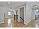 Second floor hallway features hardwood flooring, stairway access, and multiple interior entrances at 210 Short Rd, Sharpsburg, GA 30277