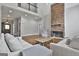 Large living room with stone fireplace, hardwood floors, and a view of the second floor at 210 Short Rd, Sharpsburg, GA 30277