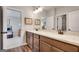Elegant bathroom featuring a double vanity, marble countertops, and modern fixtures with view to bedroom at 10140 Grandview Sq, Duluth, GA 30097