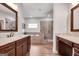 Well-lit bathroom featuring double vanity sinks and separate tiled shower and tub at 10140 Grandview Sq, Duluth, GA 30097