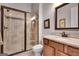 Bathroom featuring a glass enclosed shower, tile surround, granite vanity and faucet, and a large mirror at 10140 Grandview Sq, Duluth, GA 30097