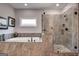 Elegant bathroom featuring a glass shower and a soaking tub with tiled surround at 10140 Grandview Sq, Duluth, GA 30097
