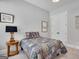 Cozy bedroom features neutral walls, plush carpet, a full bed, and a lamp on a bedside table at 10140 Grandview Sq, Duluth, GA 30097