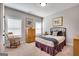 Cozy bedroom with a rocking chair and comfortable bed bathed in natural light at 10140 Grandview Sq, Duluth, GA 30097