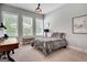 Well-lit bedroom with neutral walls, plush carpet, a full bed, and three windows offering natural light at 10140 Grandview Sq, Duluth, GA 30097