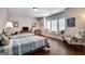 Cozy bedroom with two beds, window seating area, and hardwood floors, perfect for a relaxing retreat at 10140 Grandview Sq, Duluth, GA 30097