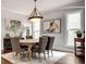 Cozy dining room with a rustic table, art, and natural light from the windows at 10140 Grandview Sq, Duluth, GA 30097