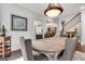 Charming dining area showcasing a rustic round table and staircase access at 10140 Grandview Sq, Duluth, GA 30097