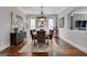 Bright dining room with wood floors, a large table, and ample natural light from the windows at 10140 Grandview Sq, Duluth, GA 30097