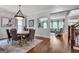 Elegant dining room features hardwood floors, a rustic table, and an ornate chandelier at 10140 Grandview Sq, Duluth, GA 30097