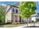 Charming two-story home with stone accents, a welcoming front porch, and mature trees in the yard at 10140 Grandview Sq, Duluth, GA 30097