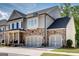 Beautiful home exterior showcasing stone accents, attached two car garage, and meticulously maintained landscaping at 10140 Grandview Sq, Duluth, GA 30097