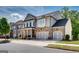 Inviting home exterior with stone accents, a welcoming porch, and an attached two-car garage at 10140 Grandview Sq, Duluth, GA 30097