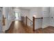 Spacious hallway with hardwood floors, detailed millwork, and elegant staircase with wood and iron railing at 10140 Grandview Sq, Duluth, GA 30097