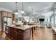 A modern kitchen with a granite island, stainless appliances, hardwood floors, and natural light at 10140 Grandview Sq, Duluth, GA 30097