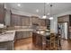 Updated kitchen with stainless steel appliances, granite countertops and center island with bar seating at 10140 Grandview Sq, Duluth, GA 30097