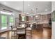 Eat-in kitchen with large island, stone backsplash, stainless appliances and breakfast area at 10140 Grandview Sq, Duluth, GA 30097