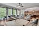 Open living room with seamless flow to kitchen, large windows, and comfortable seating at 10140 Grandview Sq, Duluth, GA 30097